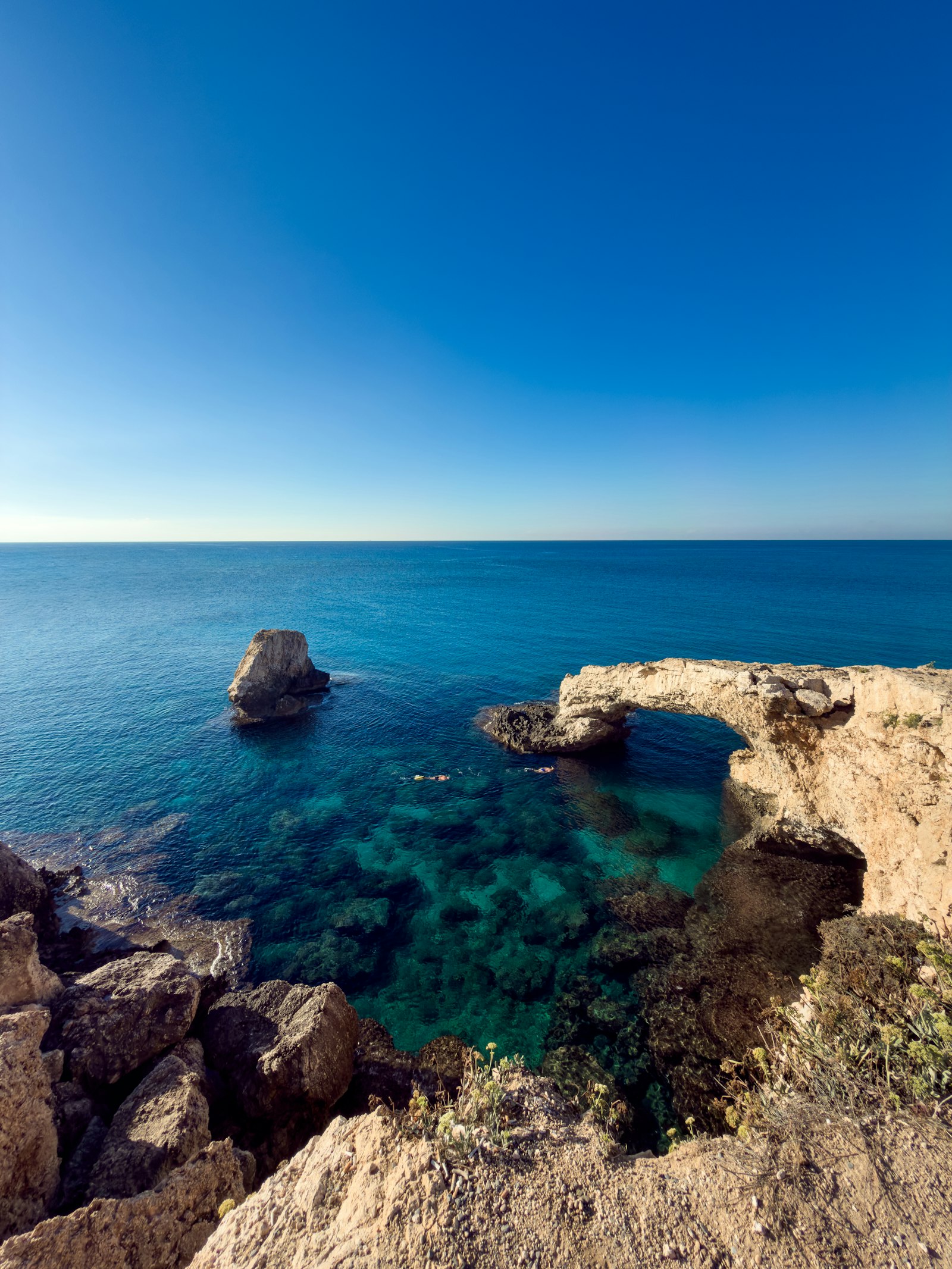 A natural rock arch over clear turquoise water at Ayia Napa, Cyprus