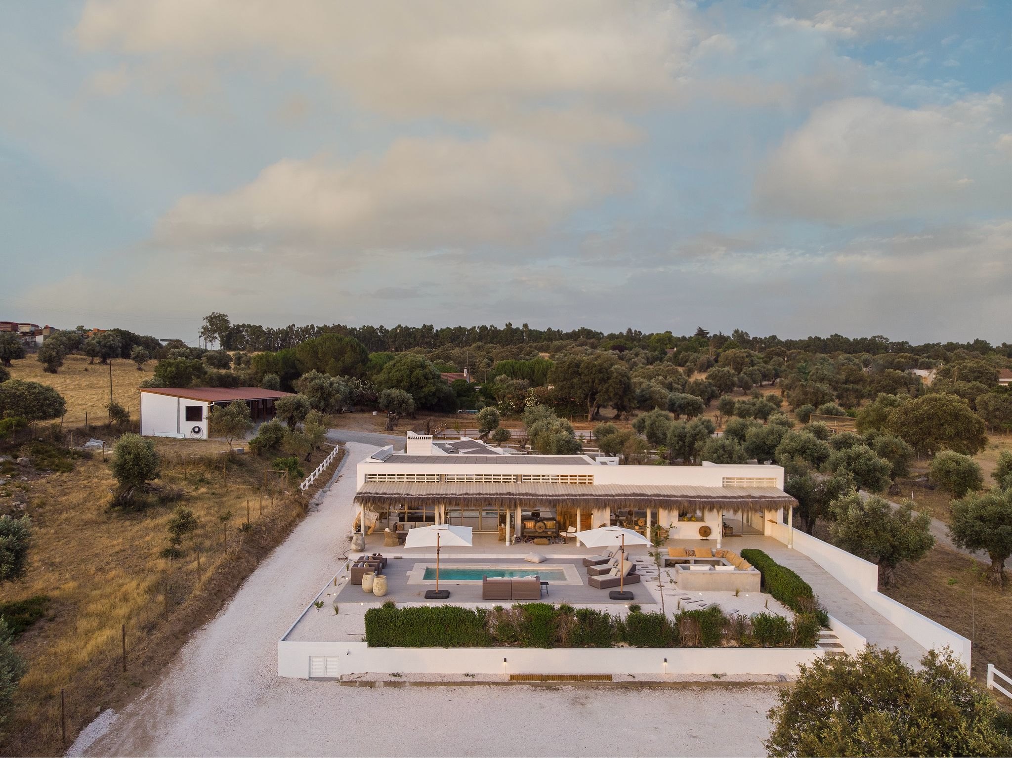 Aerial view of a single-storey farmhouse and pool on a 93-hectare equestrian and nature estate in the Baixo Alentejo